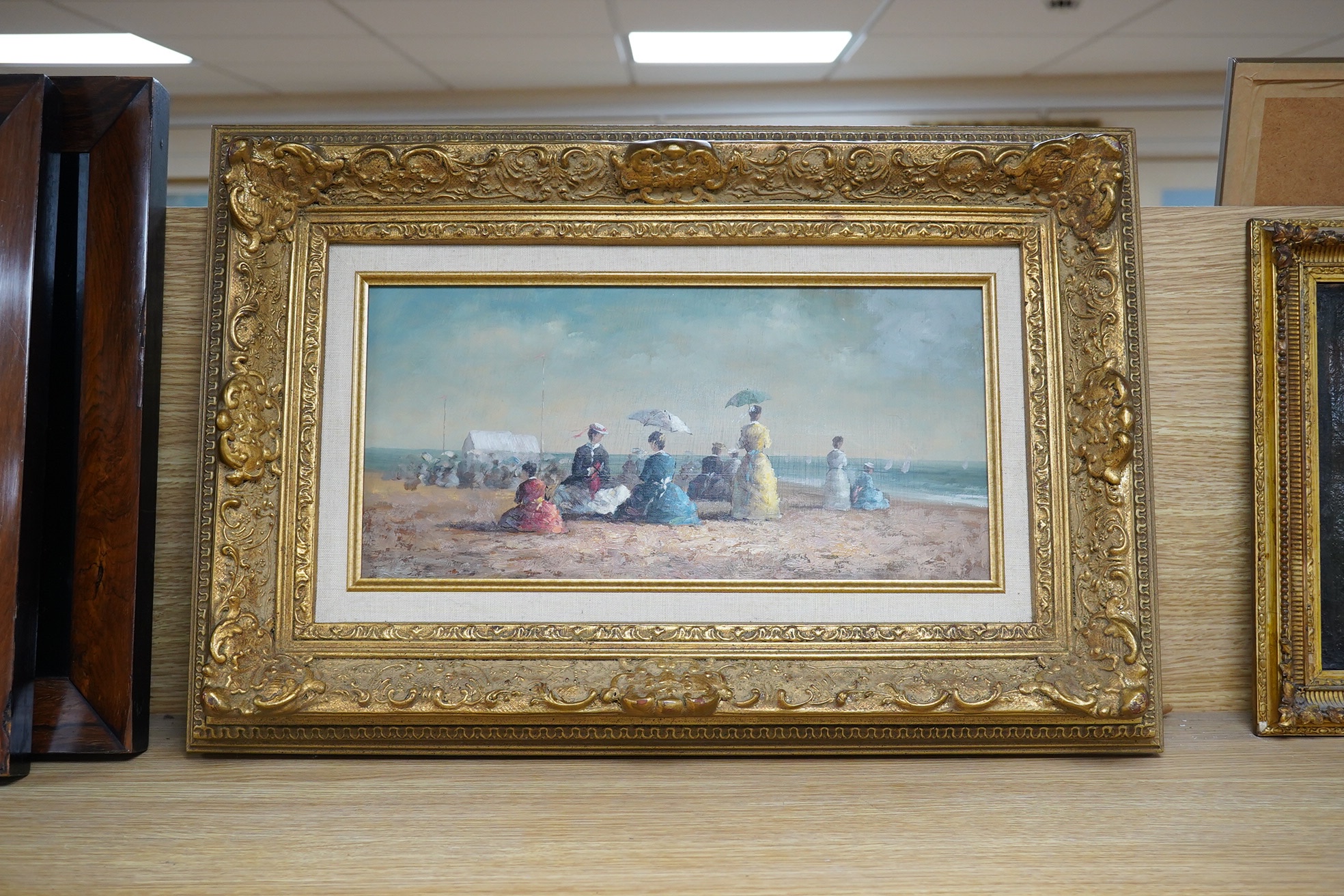 After Eugene Boudin (French, 1824-1898) impressionist oil on board, Figures on a beach, unsigned, 18 x 38cm, ornate gilt frame. Condition - good